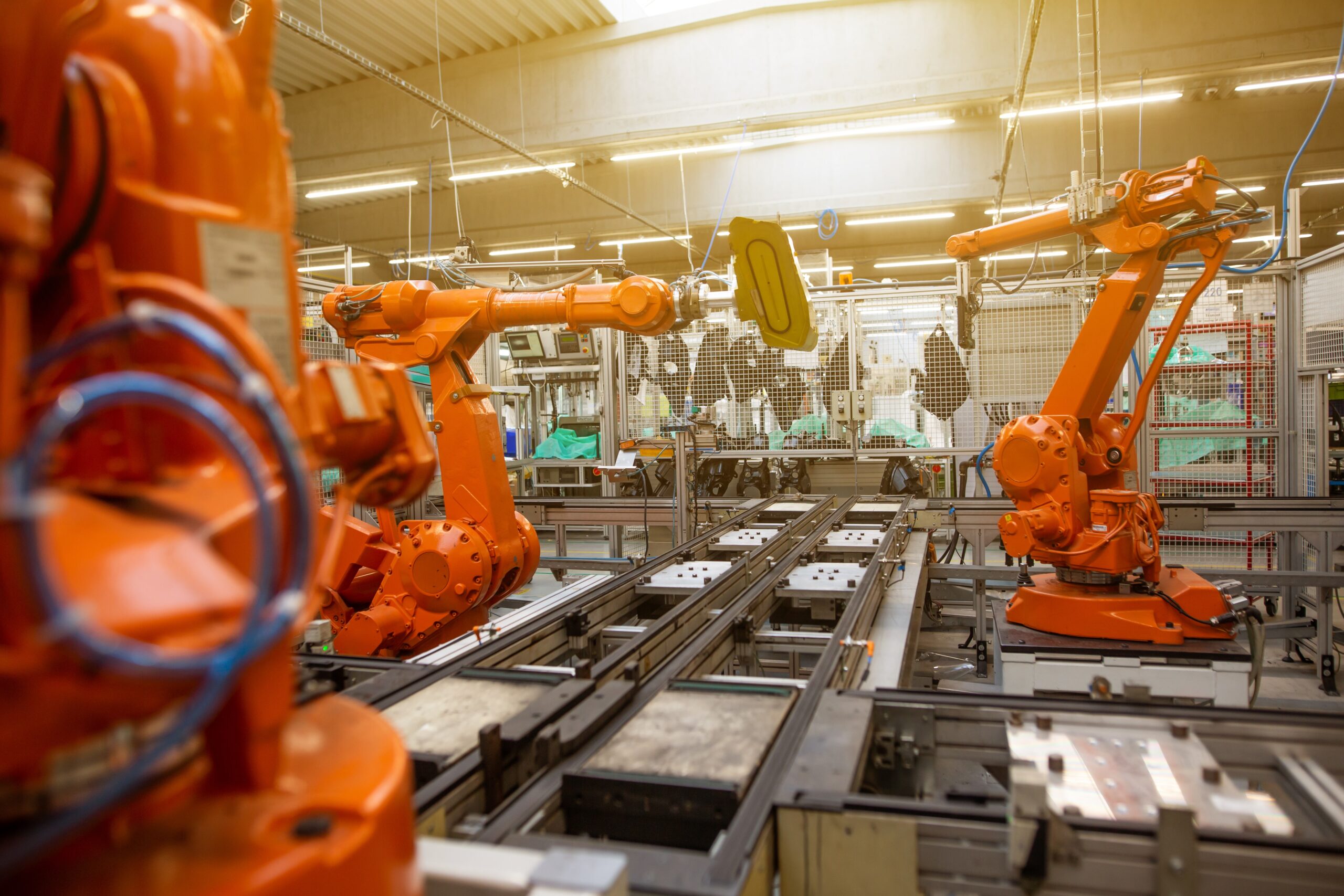 Orange Robots in manufacturing plant
