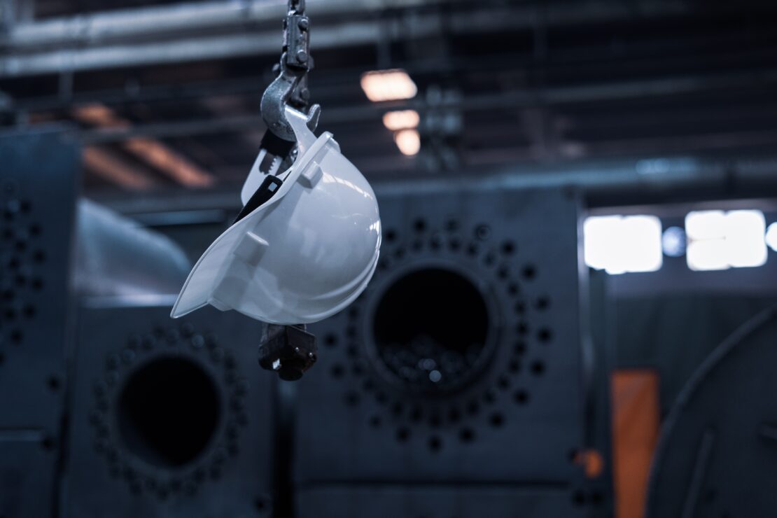 Hardhat hanging on hook in manufacturing plant
